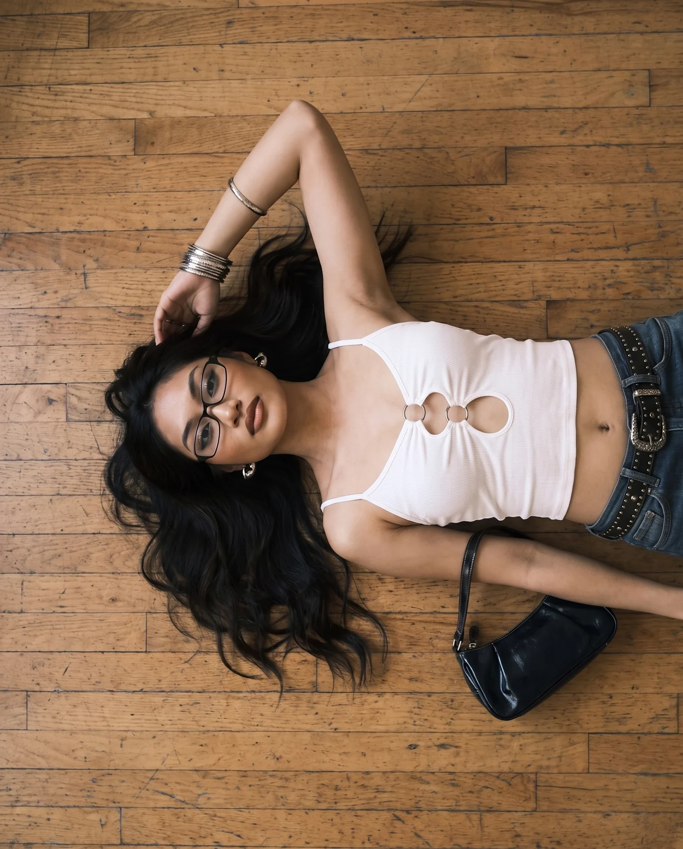 Casuall white cut-out top — lying on a wooden floor, shot from directly above