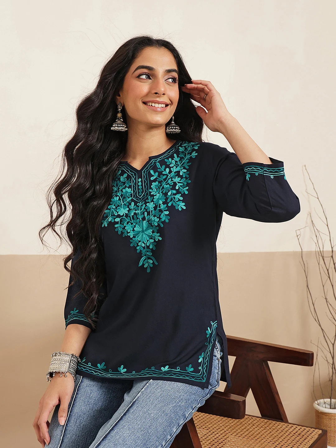 A FEMBLISS navy kurti with teal floral embroidery, styled with jeans