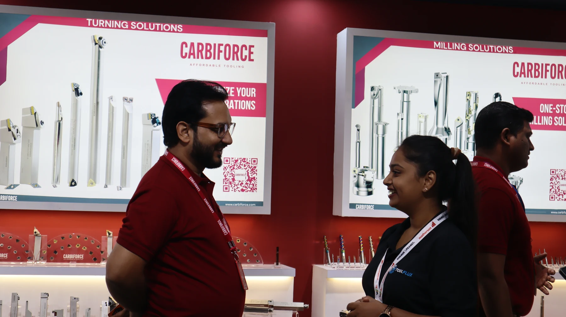 Staff in front of the turning and milling solutions wall, tools displayed in rows behind them