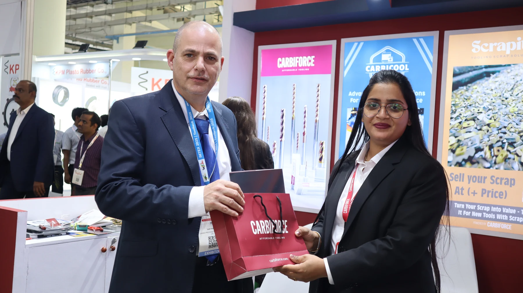 A branded Carbiforce bag being handed to a visitor at the edge of the stand