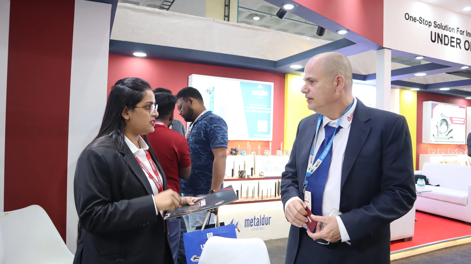 A member of the Carbiforce team showing a product to an overseas visitor