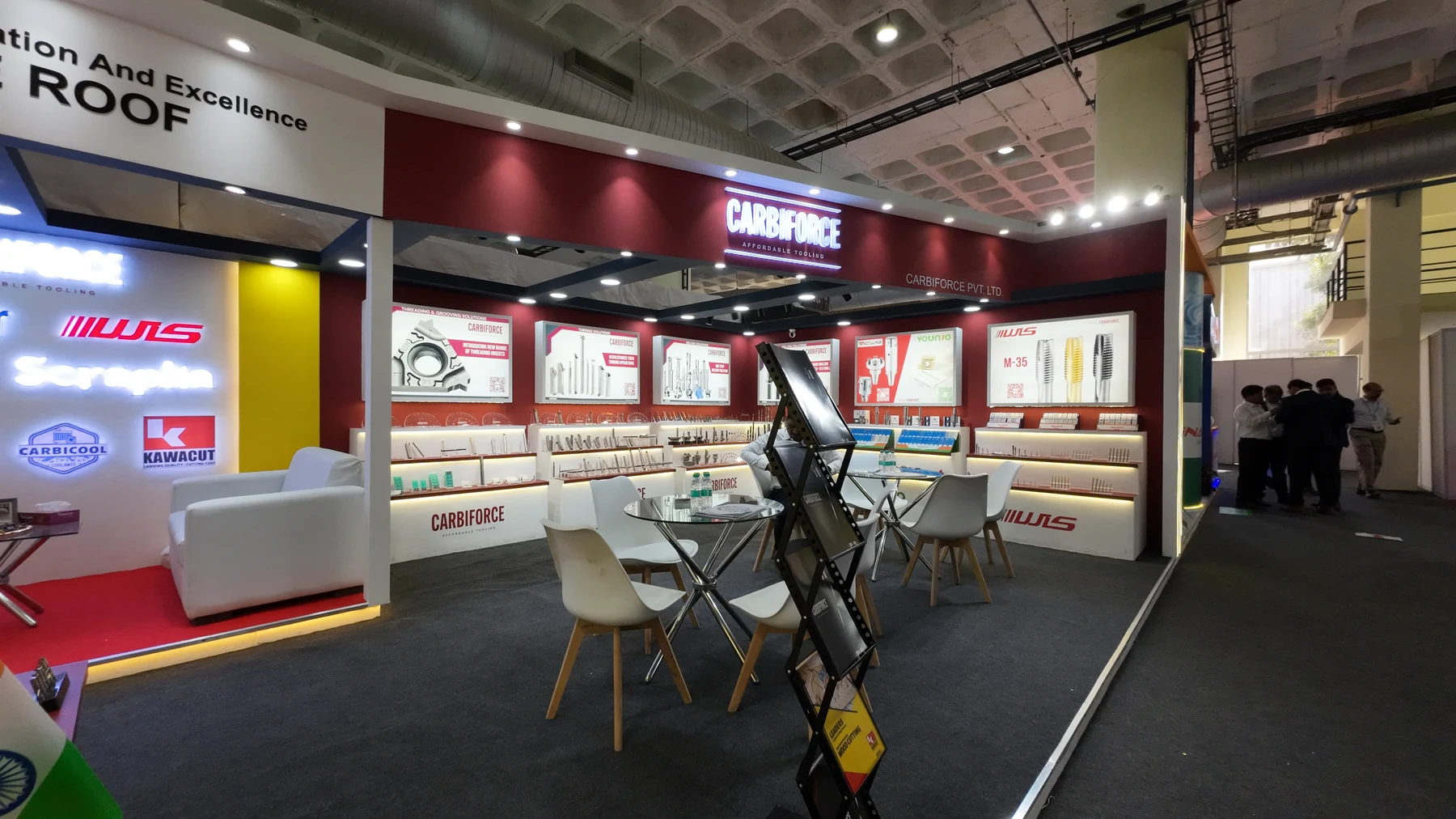 The same stand empty and lit, before the doors opened — red walls, product cases, chairs still in place